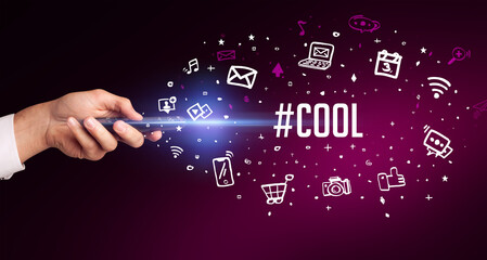 hand holding wireless peripheral with #COOL inscription, social media concept