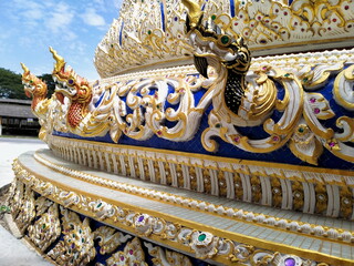 Naga sculpture on foundation of big white buddha statue at Wat Nong Pong Nok, temple. Nakhon Pathom...