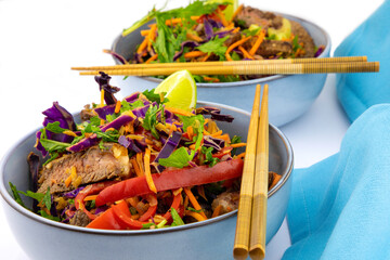 Tossed salad with steak strips and chop sticks