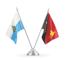 Papua New Guinea and San Marino table flags isolated on white 3D rendering