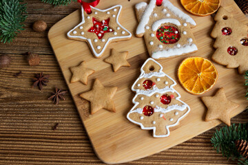 Christmas homemade gingerbreads  with spices, dried oranges on wooden table.