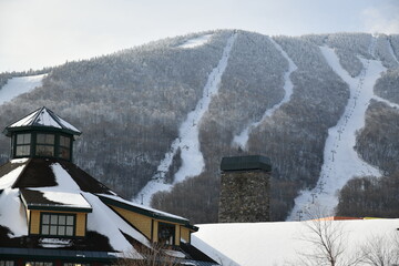 View to the Stowe Mountain Ski Resort lodge and peak Mansfield slopes from  Spruce peak in mid...