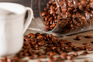Coffee beans and a cup of espresso on a wooden plank. 