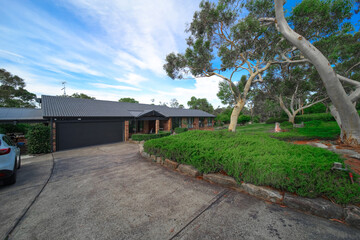Residential house in Dural a country suburb in Sydney NSW Australia with lush green trees and grass 