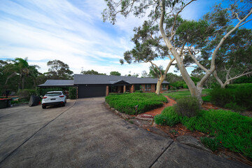 Residential house in Dural a country suburb in Sydney NSW Australia with lush green trees and grass 