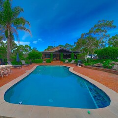 Residential house in Dural a country suburb in Sydney NSW Australia with lush green trees and grass 