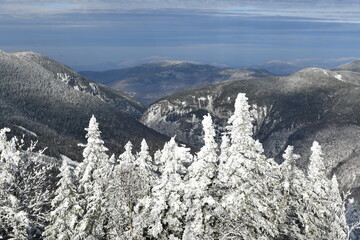 Stowe Ski Resort in Vermont, view to the Mansfield mountain slopes, December fresh snow on trees early season in VT, panoramic hi-resolution image