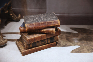 Stack of antique books in a dilapidated cover with the edges torn off