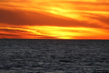 Amazing shades of orange complimented by blue water and bright reflections on the water 