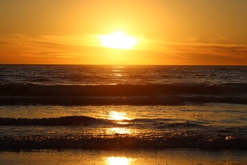 Amazing shades of orange complimented by bright reflections on the water make this southern california sunset both brilliant and stunning