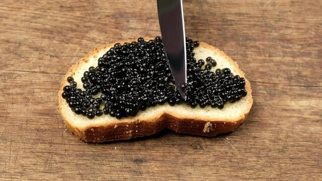 delicious black paddlefish caviar and a slice of bread made from white wheat flour, close up