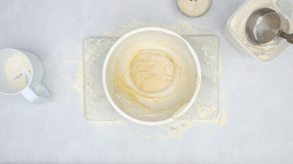 Bread dough in a bowl, flat lay. Step by step homemade cheese bread recipe, baking process