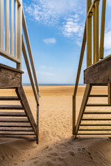 Standing between two Beach Huts in Wells-next-the-Sea, Norfolk, England, UK