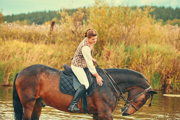 The rider and the horse went into the water to water the horse