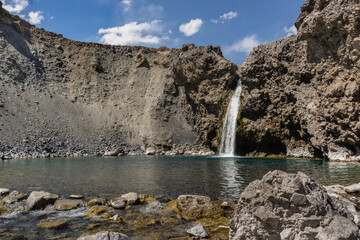 Impressive horizontal photo of turquoise light blue waterfall located in the Cajon del Maipo, Andes...