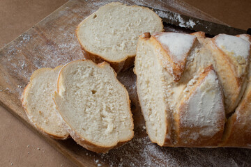 Italian bread sliced ​​on wooden board