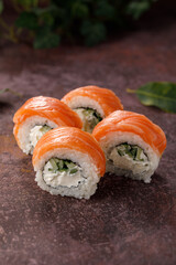 Philadelphia roll sushi on textured background still life. Restaurant concept. Close-up.