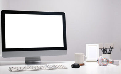 Modern workspace with computer  with blank screen and equipment on white table.Blank screen for your information.