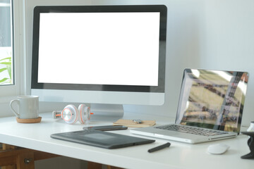 Modern workspace with computer with blank screen and equipment on white table.Blank screen for your information.
