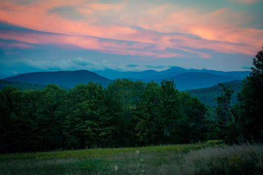 The sun sets over the Adirondack Mountains near Saranac Lake, New York