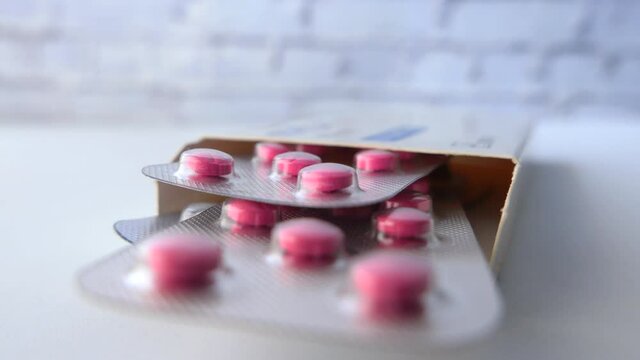 pills of blister pack in a packer on table 