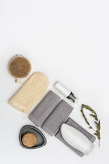 Spa still life background. Set for body care on white. Bottles with gel or shampoo, soap, wooden comb, washcloth for bath.