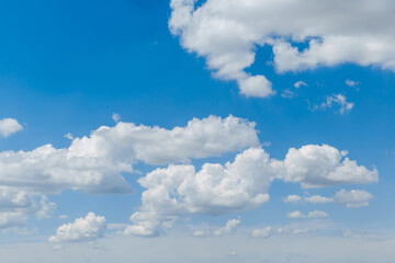 Blue clear sky with white fluffy clouds. Natural background. Copy space