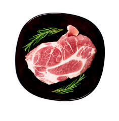 Pieces of raw pork steak in black plate.top view