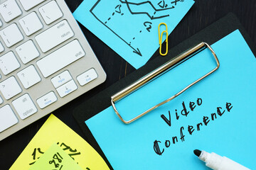 Business concept about Video Conference with phrase on the piece of paper.