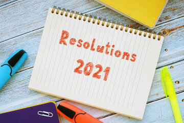 Conceptual photo about Resolutions 2021 with handwritten text.