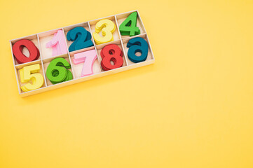 A math game for junior age with colored wooden signs of numbers