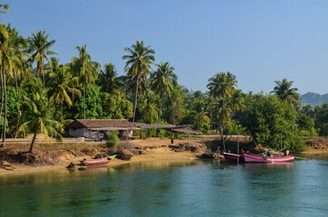 Boats on river near tropical shore in Gwa Myanmar