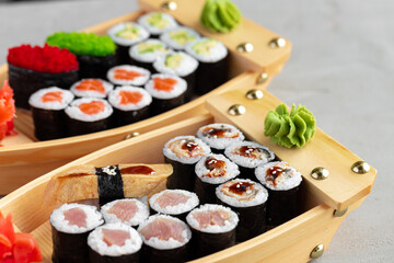 Set of maki sushi on wooden boat tray