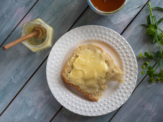 Sandwich with honey on bran bread and semolina with honey and honey spoon