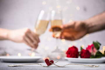 Crop close up of man and woman hold glasses with champagne or vine clink greet congratulate with valentines day against white background. Celebration concept.