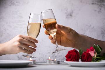 Crop close up of man and woman hold glasses with champagne or vine clink greet congratulate with valentines day against white background. Celebration concept.