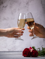 Crop close up of man and woman hold glasses with champagne or vine clink greet congratulate with valentines day against white background. Celebration concept.