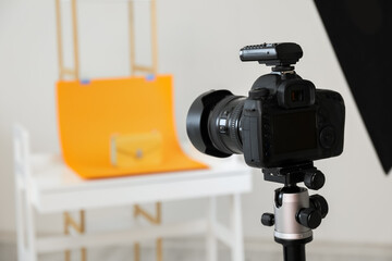 Professional camera on tripod in modern photo studio