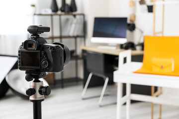 Professional camera on tripod in modern photo studio