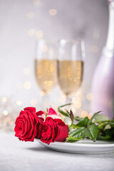 Valentines day table setting  red roses and champagne glasses on concrete background. Valentine 's greeting card - Image