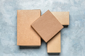 Blank cardboard boxes on color background