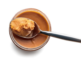 Jar of peanut butter and spoon isolated on white background