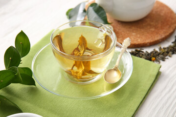 Cup of green tea on table