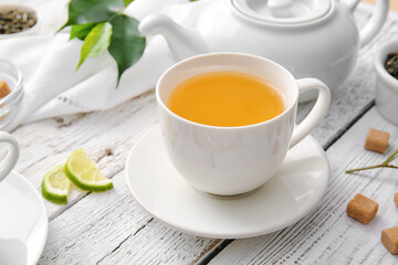 Composition with cup of green tea on table