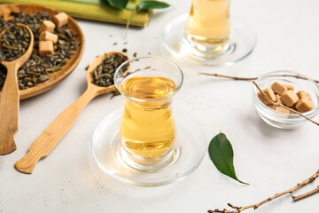 Composition with glasses of green tea on table