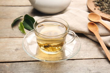 Cup of green tea on wooden table