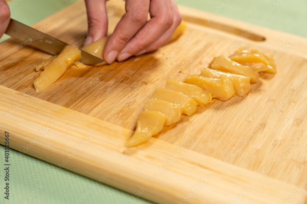 Sticker A chef cutting free-range chicken breast on a chop