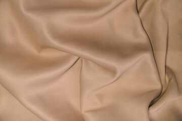 Abstract background of luxury fabric.Folds in waves of silk fabric. The texture of the satin material.