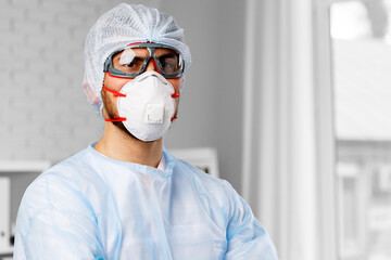 Young male doctor wearing protective medical uniform