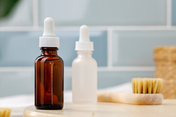 Glass cosmetic oil bottles with pipette in bathroom